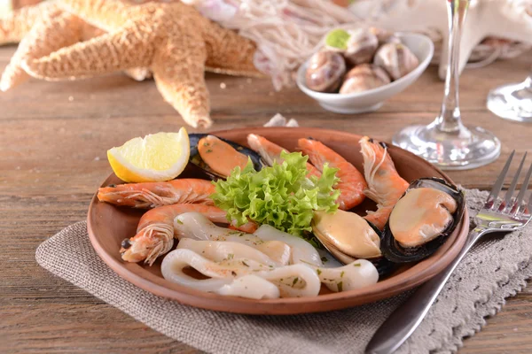 Tasty seafood on plate on table close-up — Stock Photo, Image