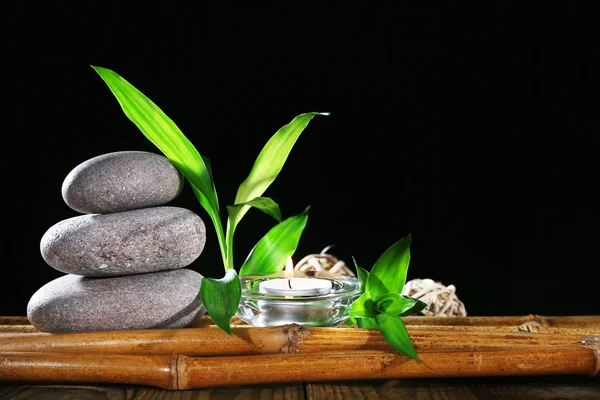 Beautiful composition with spa stones and candle on table on dark background — Stock Photo, Image