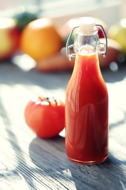 Domates suyu meyve ve sebzeler üzerinde pencere ile şişe