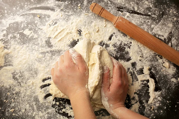 Making dough by female hands on wooden table background — Stock Photo, Image