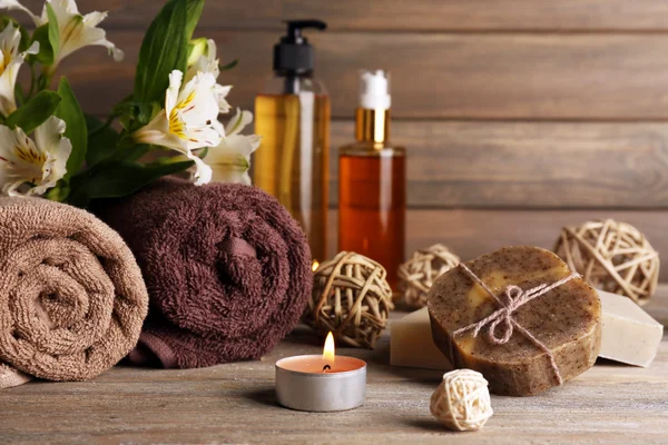 Beautiful spa composition with soap and candle on wooden background