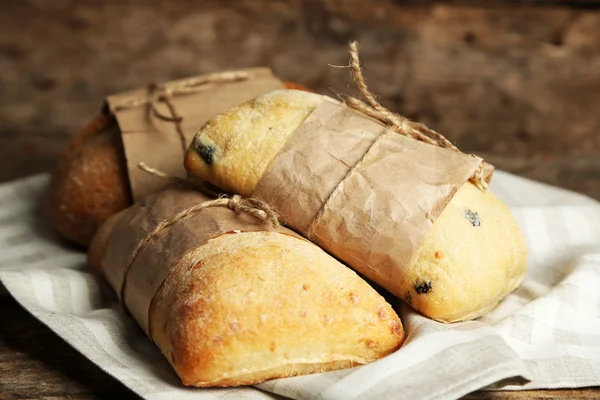 Fresh bread on old wooden table — Stock Photo, Image