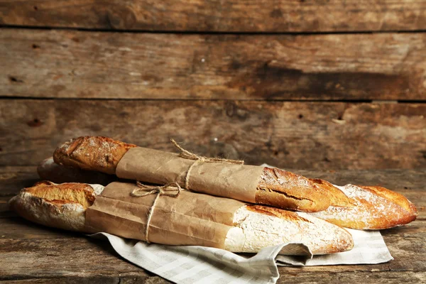 Fresh bread on old wooden table — Stock Photo, Image