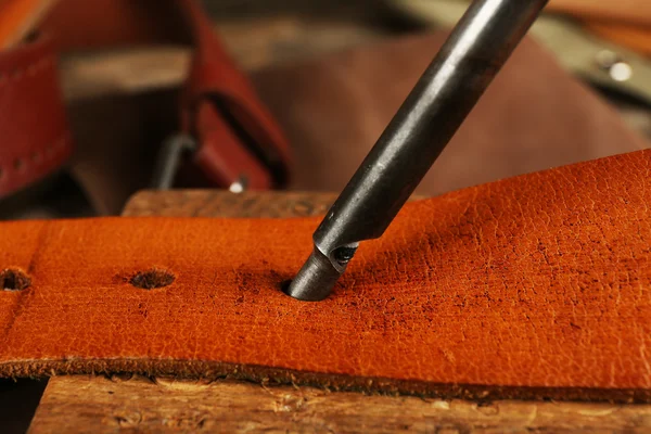 Leather belt and punches on table close up — Stock Photo, Image