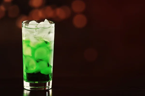 Green cocktail on table on brown background — Stock Photo, Image