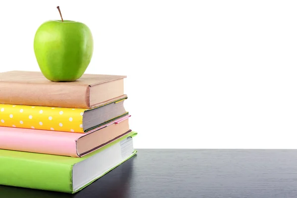 Libros y manzana en el escritorio, aislados en blanco — Foto de Stock