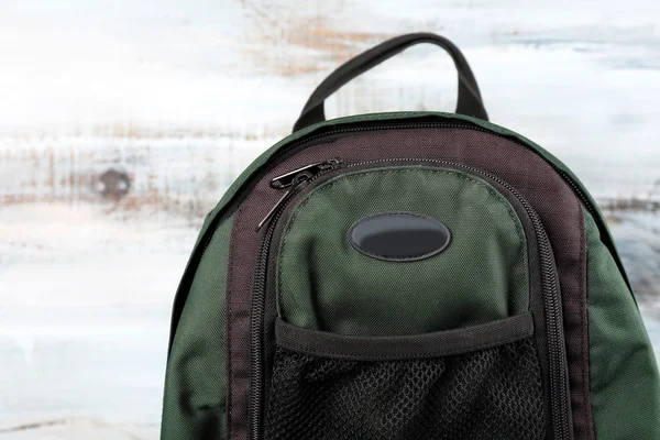 Backpack on wooden background — Stock Photo, Image