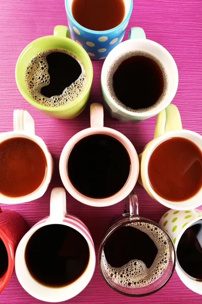 Muitas xícaras de café na mesa rosa, vista superior — Fotografia de Stock