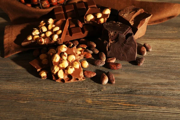木製の背景上のナッツとチョコレートのセットのある静物 — ストック写真