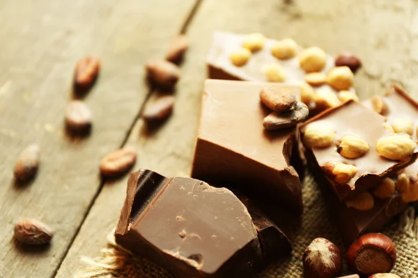 Still life with set of chocolate with nuts on wooden table, closeup — Stock Photo, Image