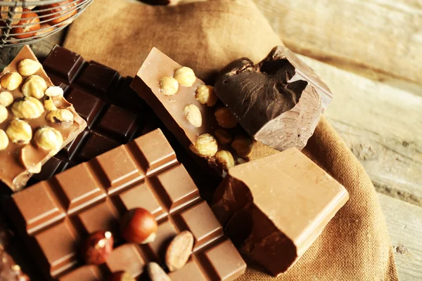 Natureza morta com conjunto de chocolate com nozes em pano de serapilheira, close-up — Fotografia de Stock