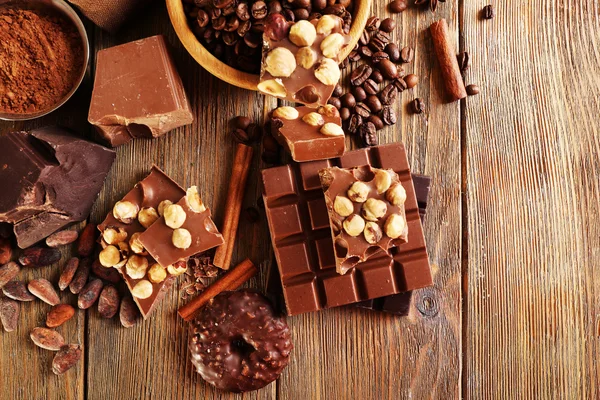 Still life with set of chocolate on wooden table, top view — Stock Photo, Image