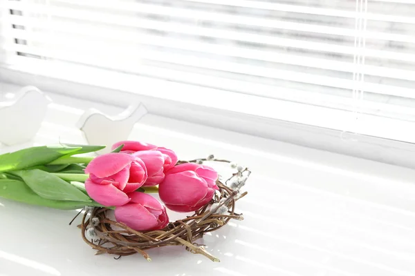 Pink beautiful tulips on windowsill with sunlight — Stock Photo, Image