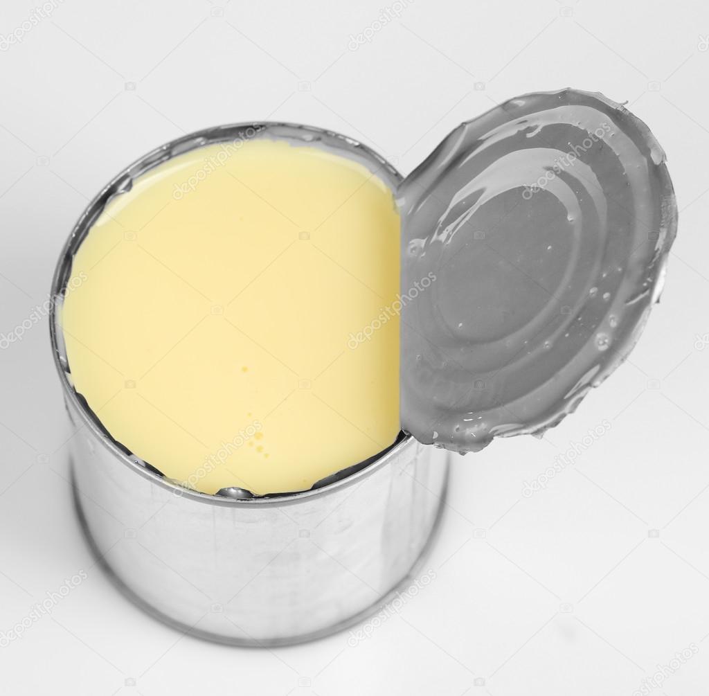 Tin can of condensed milk isolated on white
