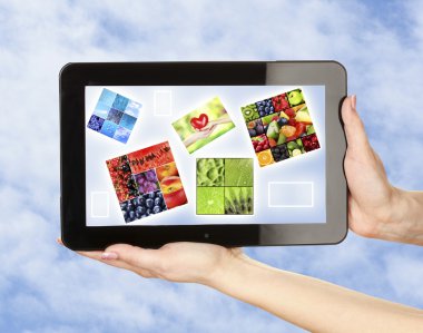 Touch screen tablet with beautiful images on sky background clipart