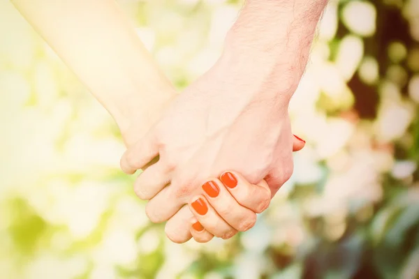 Loving couple holding hands outdoors — Stock Photo, Image