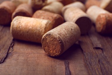 Wine corks on rustic wooden table background clipart