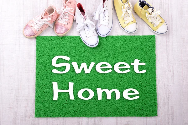 Green carpet on floor and converse close-up — Stock Photo, Image