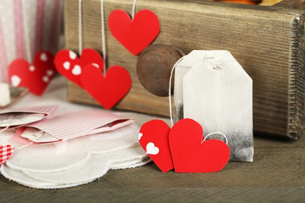 Heart shaped teabag tags on wooden background — Stock Photo, Image