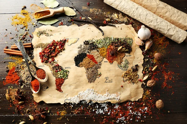 Map of world made from different kinds of spices on wooden background — Stock Photo, Image