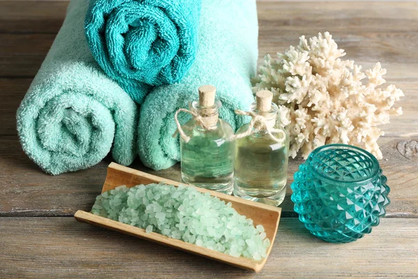 Spa composition with towels and sea salt on on wooden table — Stock Photo, Image