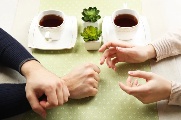 Female and male hands with cups of tea, close-up — Stock Photo, Image