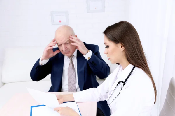 Young female doctor receiving patient in her office — Stock Photo, Image