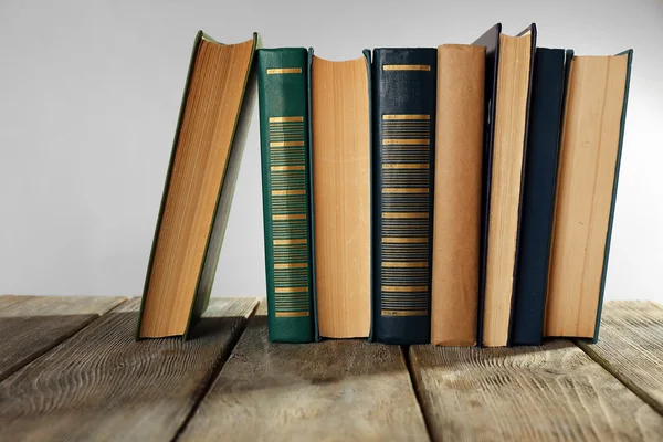 Old books on wooden table on gray background — Stock Photo, Image