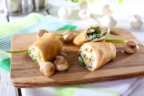 Pancakes with cream and mushrooms on wooden table, closeup — Stock Photo, Image