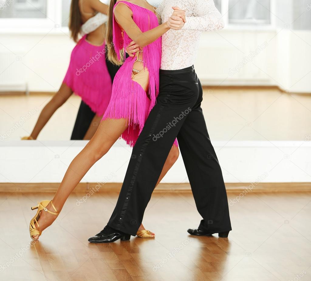 Beautiful couple in active ballroom dance, indoors