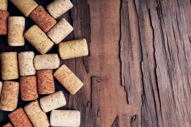 Wine corks on rustic wooden table background clipart