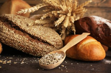 Kulakları ve ahşap arka plan ayçiçeği tohumu ile farklı ekmek