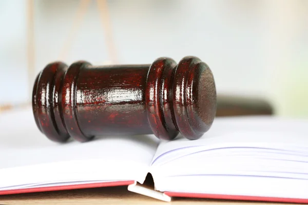 Wooden judges gavel lying on law book, close up — Stock Photo, Image