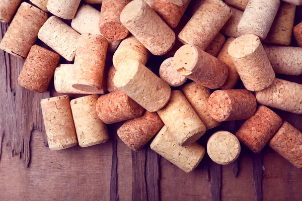 Wine corks on rustic wooden table background — Stock Photo, Image