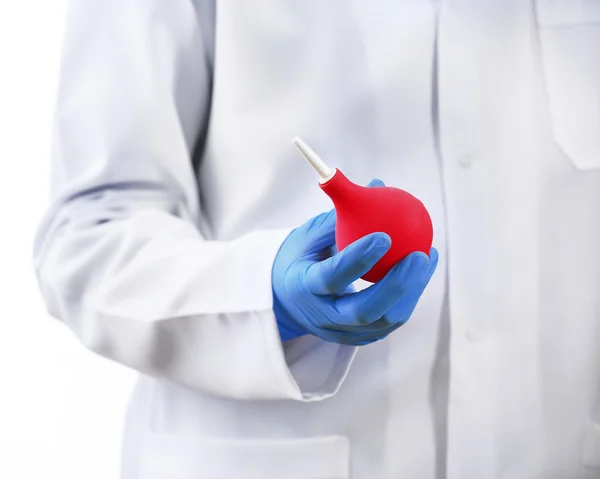 Doctor hand in gloves with medical pink enema syringe isolated on white background — Stock Photo, Image