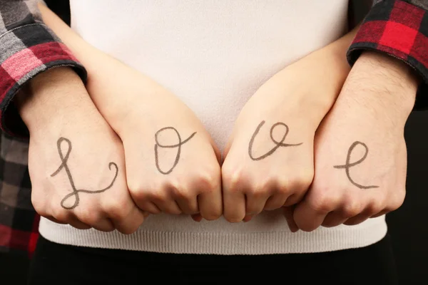 Hands of couple with inscription Love, close-up view — Stock Photo, Image