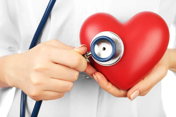 Doctor hands with heart and stethoscope on white background. closeup — Stock Photo, Image