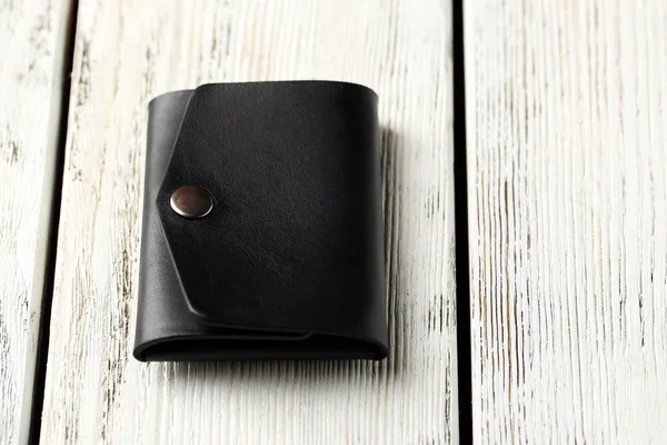 Hand made leather man wallet on white wooden background — Stock Photo, Image