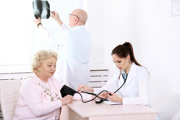 Médicos felices y paciente en clínica hospitalaria — Foto de Stock