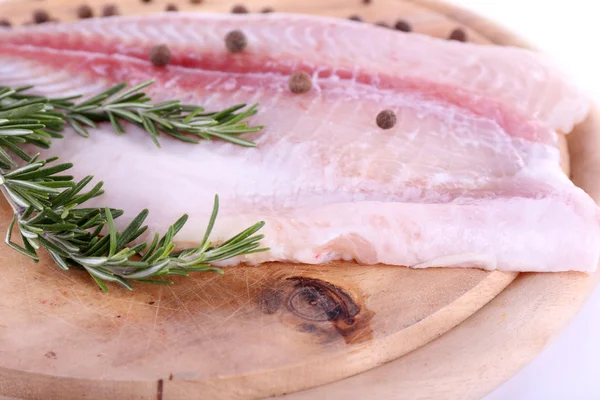 Pangasius fillet on wooden cutting board on white background — Stock Photo, Image