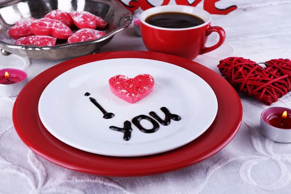 Cookie in form of heart on plate with inscription I Love You on color wooden table background — Stock Photo, Image