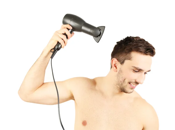 Bonito jovem golpe secando seu cabelo isolado em branco — Fotografia de Stock