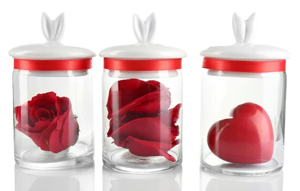 Rose flower, petals and decorative heart in glass jars  isolated on white — Stock Photo, Image