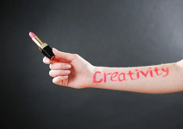 Word creativity written on female hand on black background — Stock Photo, Image