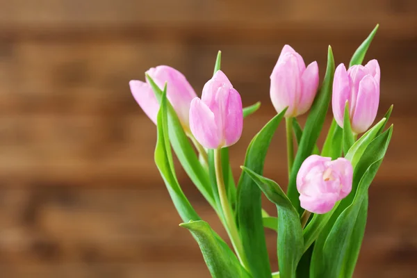 Beautiful pink tulips on wooden background — Stock Photo, Image