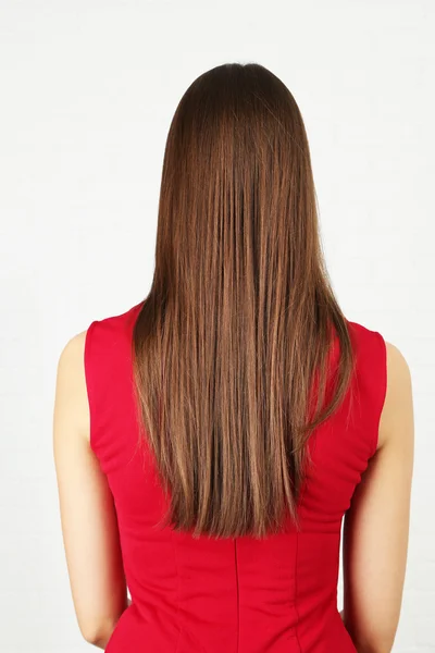 Long shine female hair on light background — Stock Photo, Image