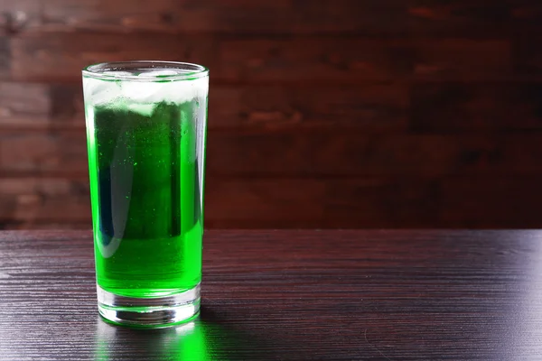 Green cocktail on table on brown background — Stock Photo, Image