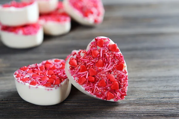 Deliciosos caramelos de chocolate en forma de corazón en primer plano de la mesa —  Fotos de Stock