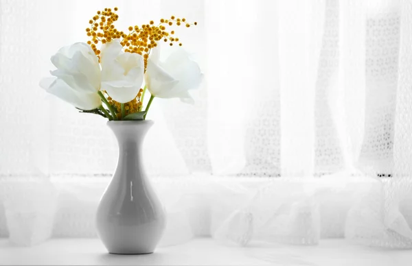 Beautiful spring bouquet in vase on windowsill — Stock Photo, Image