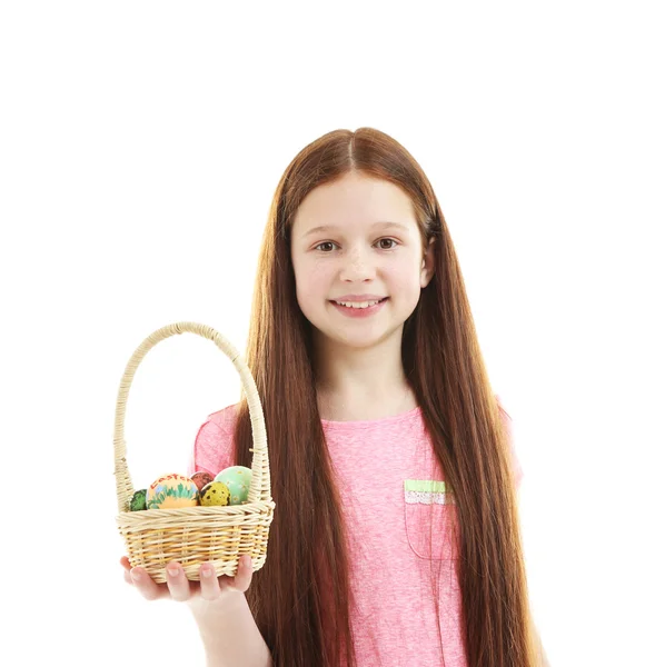 Beautiful little girl holding wicker basket with Easter eggs, isolated on white — Stock Photo, Image